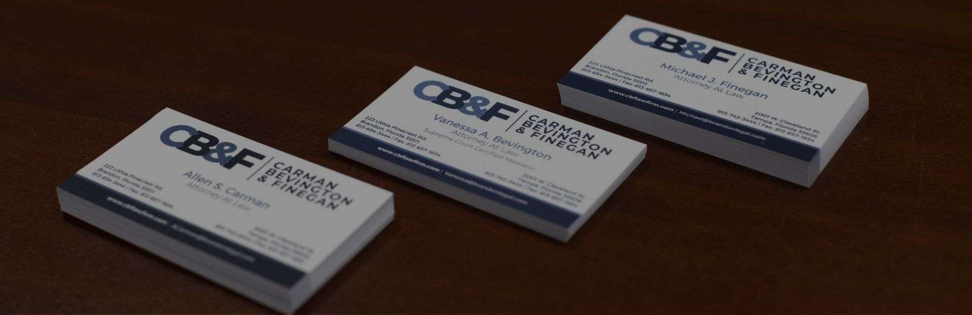 Carman & Finegan Business cards on a desk