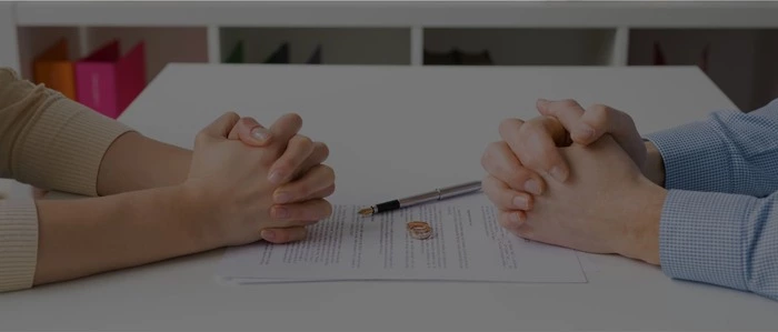 Couple going through divorce signing papers